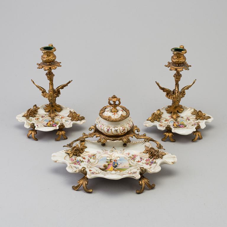 A porcelain and metal ink stand and pair of candlesticks from Seger, Germany, early 20th Century.