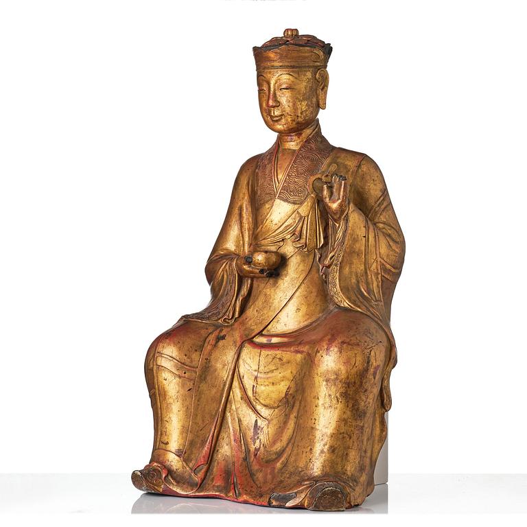 A large gilt lacquer figure of a deity, Vietnam, 19th century.