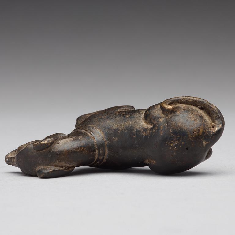 A bronze figure of a reclining dog, Ming dynasty (1368-1644).