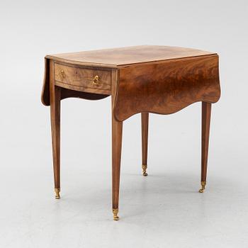 A mahogany drop leaf table from around the year 1900.