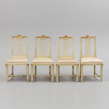 A lot of four mid 20th century Swedish Gustavian style chairs and one dinner table from around year 1900.