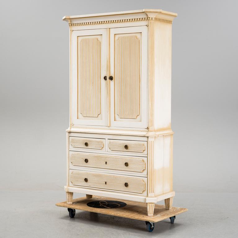 A gustavian style cabinet, circa 1900.