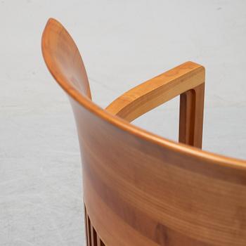 A model 606 'Barrel' chair by Frank Lloyd Wright for Cassina, designed 1937.