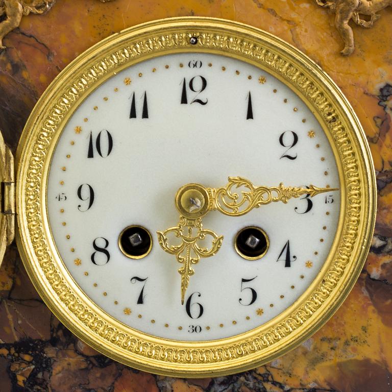 A turn of the century 1900 gilt brass and marble century mantle clock.