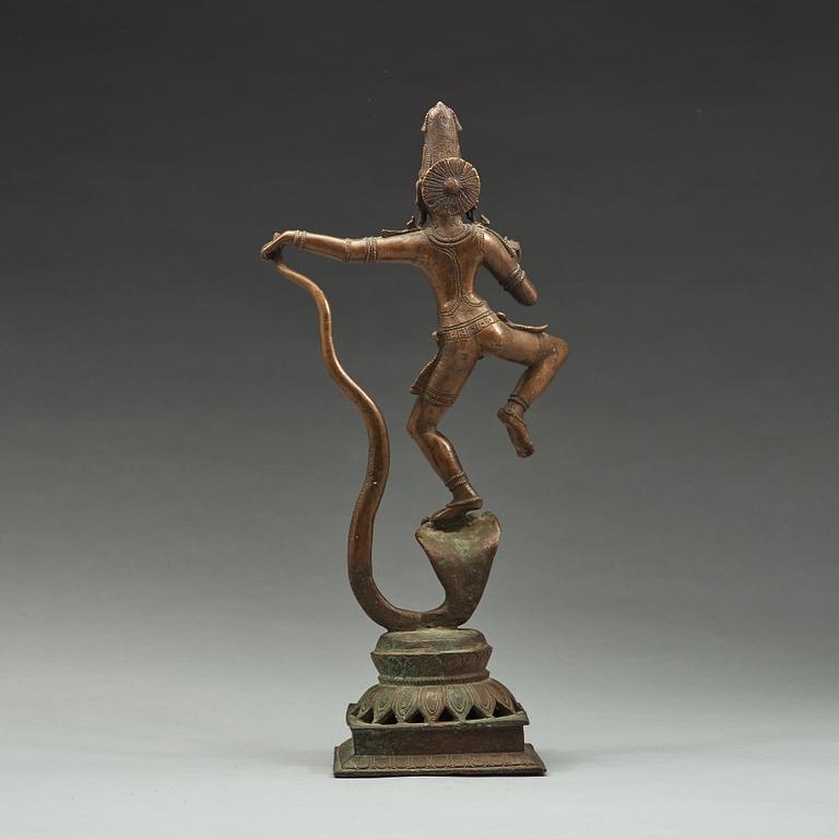 A bronze scupture of Krishna who has konkured the five headed serpant, India, early 20th Century.