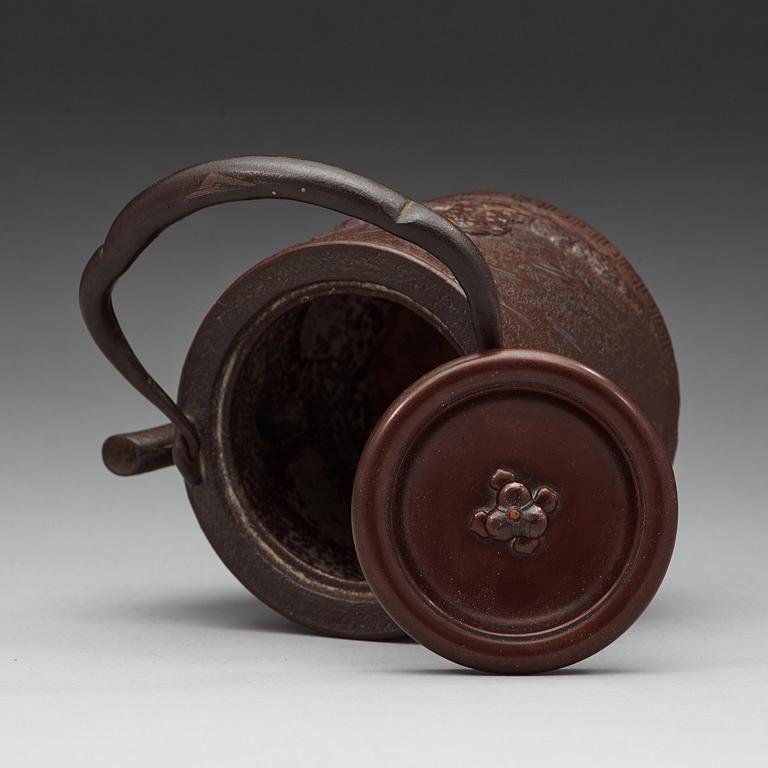 A Japanese iron and bronze tea pot with cover, Meiji period 1868-1912).