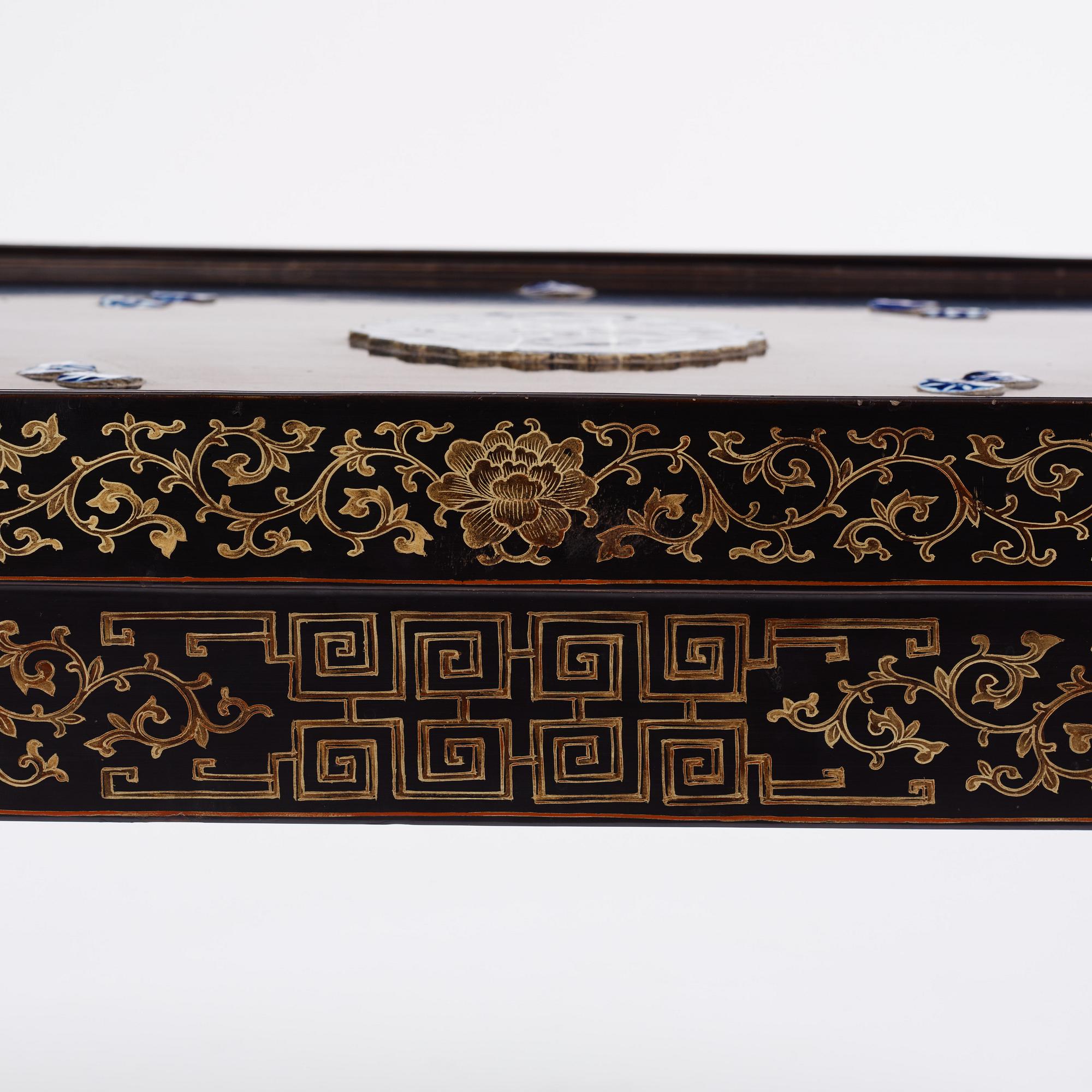 A Chinese black lacquered table with porcelain placques, presumably first half of the 20th century.