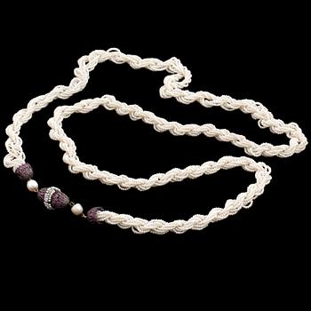 A necklace of cultured pearls and seed pearls with a silver clasp decorated with probably synthetic rubies.