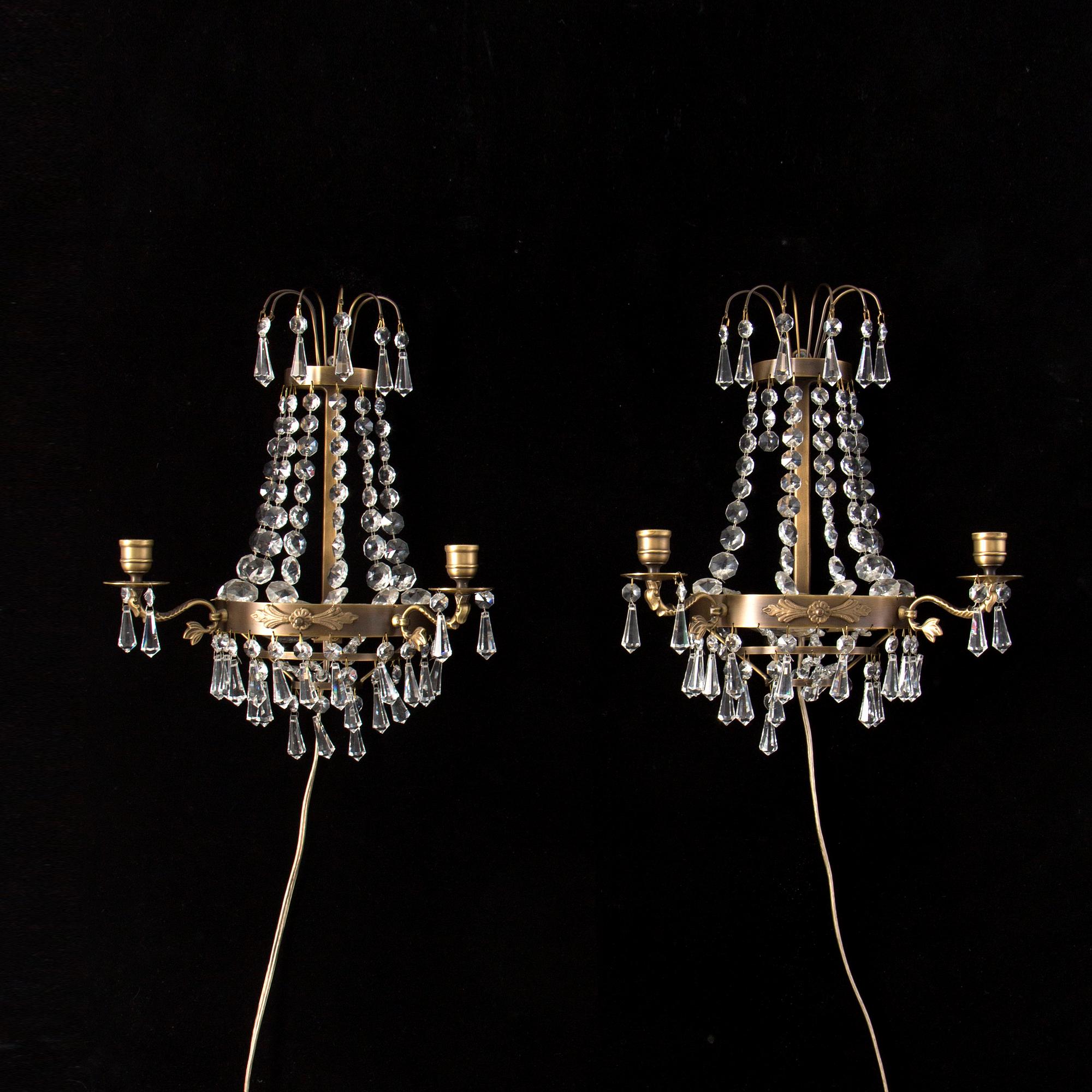 A pair of 20th century Gustavian style wall lights for two candles.