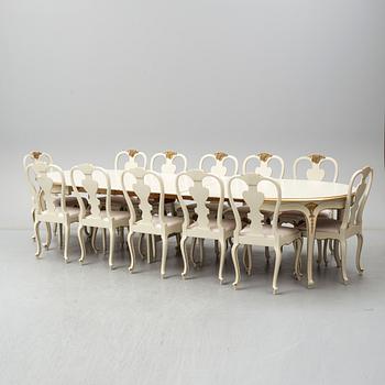 A dining table width twelve chairs, first half of the 20th century.