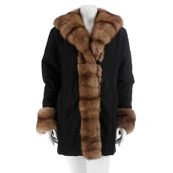 463. COAT, black with fur trim. Size 42.