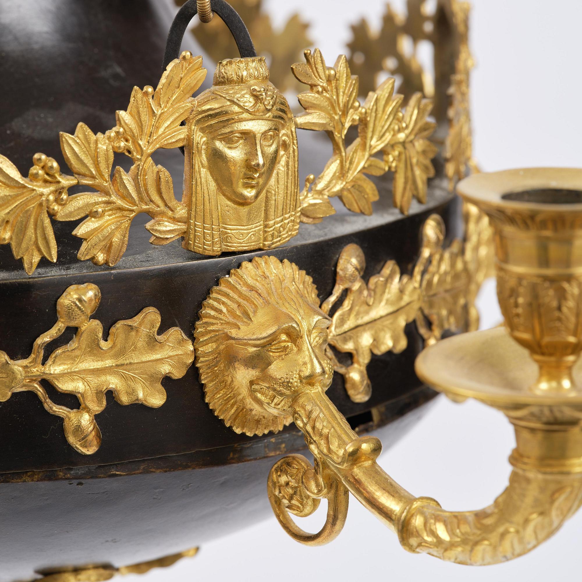 A patinated and ormolu six-light Empire chandelier, Stockholm, first part 19th century.
