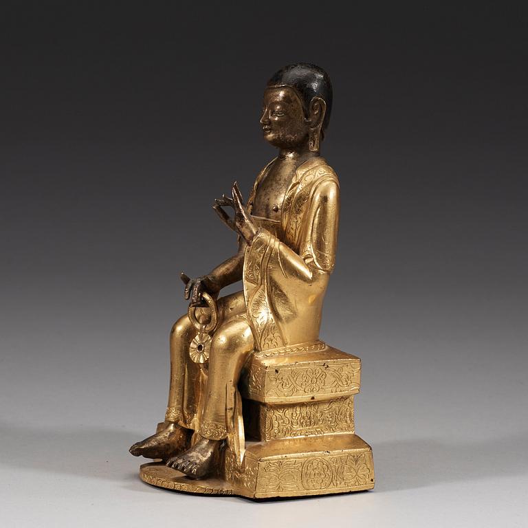 A part-gilt bronze figure of a Lohan, presumably Kalika, Tibeto-Chinese, 18th Century.