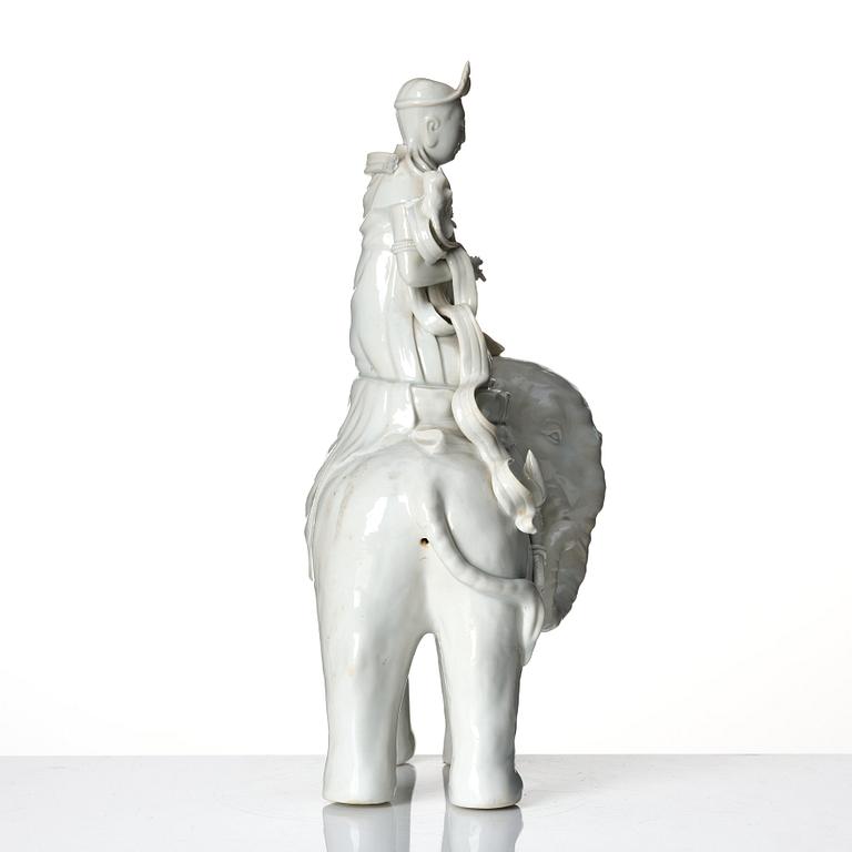 A large blanc-de-chine figure of Guanyin riding an elephant, late Qing dynasty/early 20th Century.