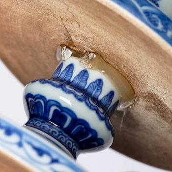 A pair of blue and white pricket candle sticks, with a poem, Qing dynasty with a Qianlong mark and of the period.