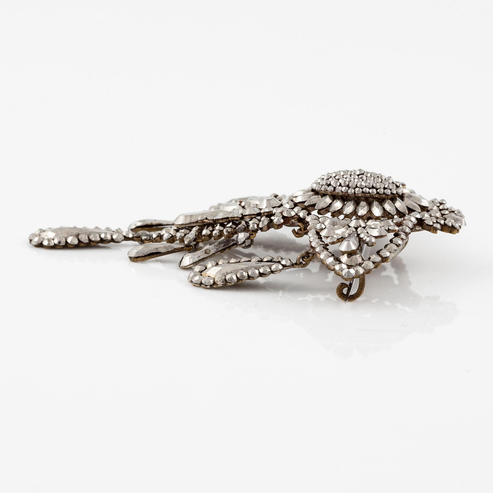 Demi parure, a pair of earrings, and a brooch, with so-called steel diamonds, 19th century.