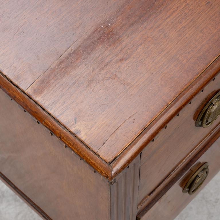 A late Gustavian mahogany and mahogany-veneered chest of drawers, beginning of the 19th century.