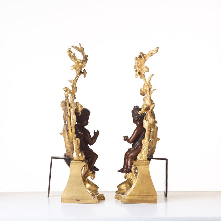 A pair of Louis XV-style 19th century fire dogs.