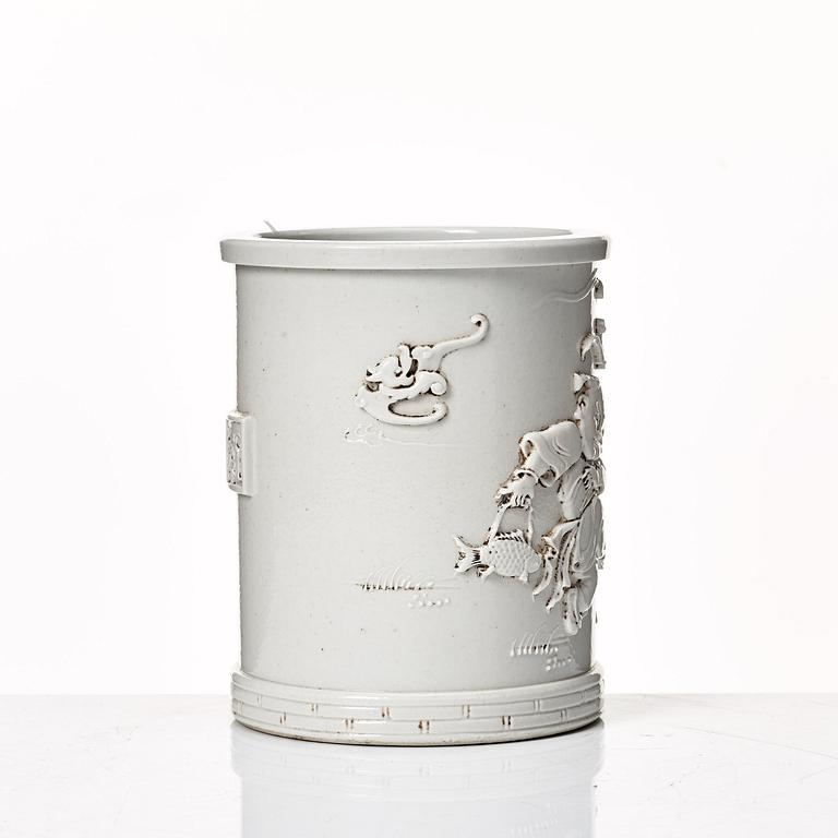 A white glazed Chinese brush pot, presumably late Qing dynasty.