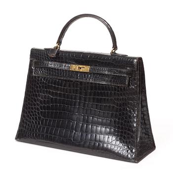 486. A 1960s/70s black crocodile leather handbag "Kelly" by Hermès.