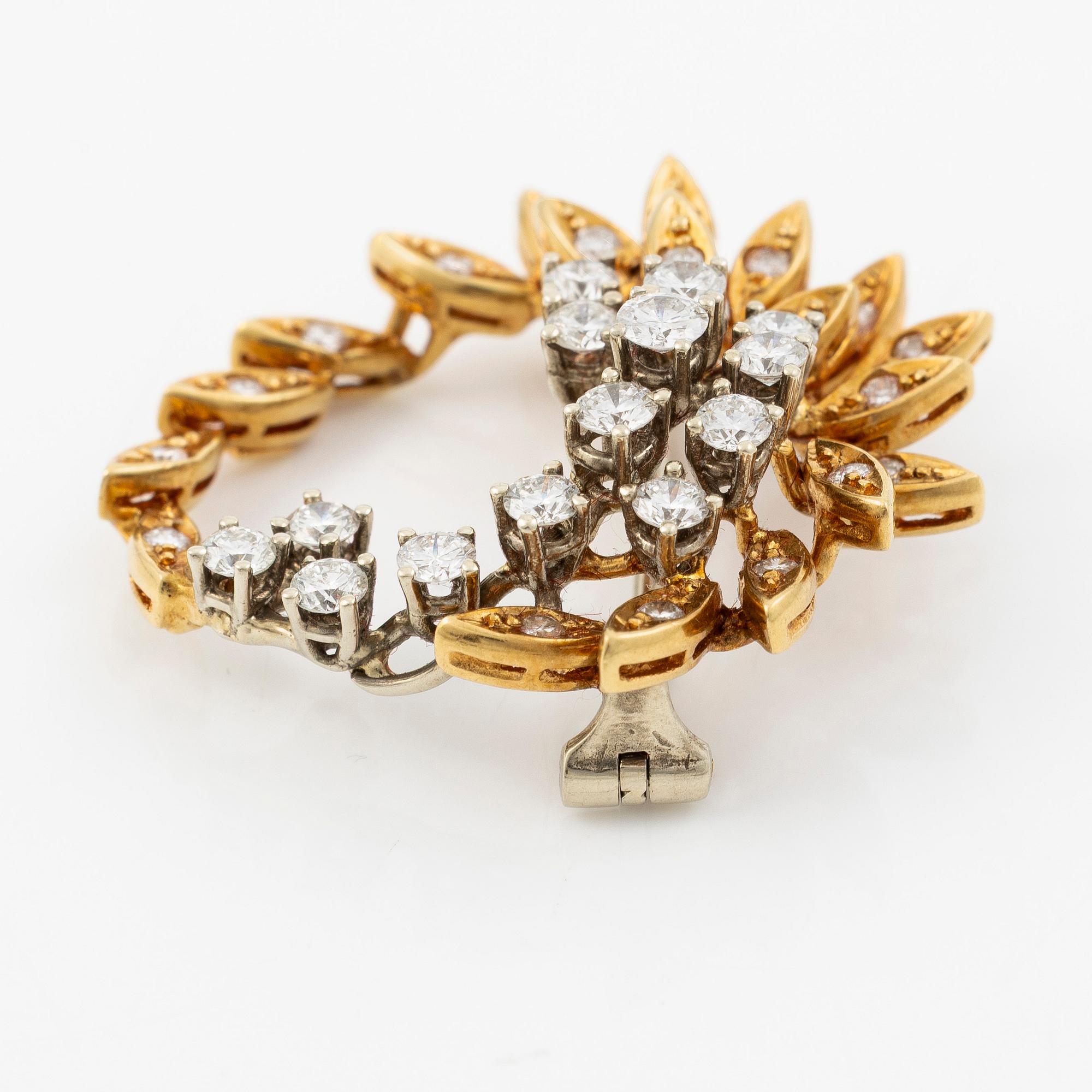 Brosch 18K guld med runda briljantslipade diamanter.
