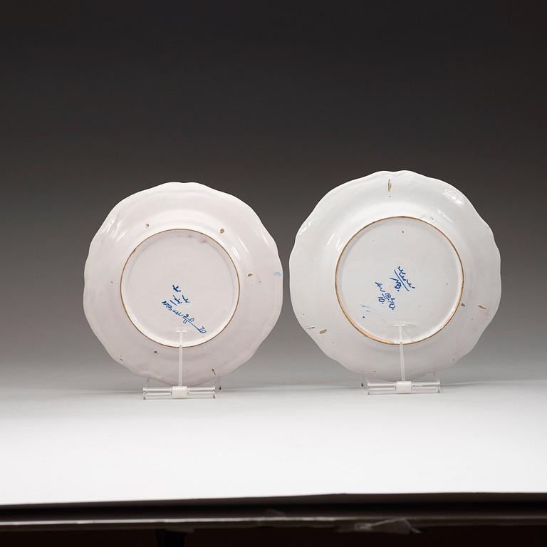 A set of two Marieberg faience dinner plates decorated in grisaille, dated 1740 and 1770.