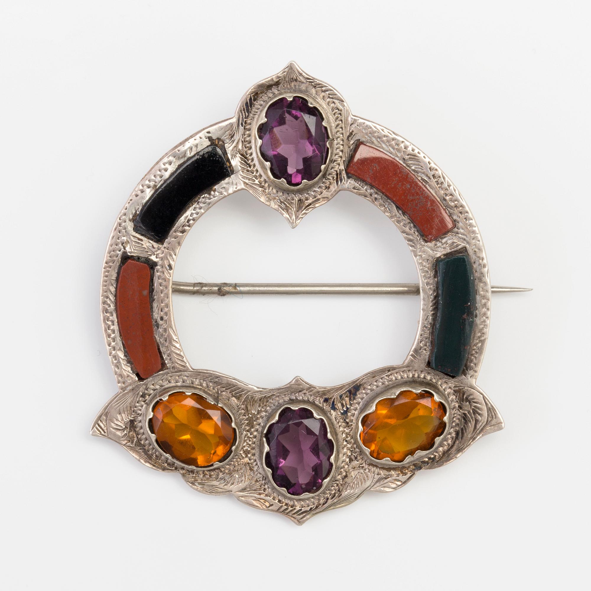 A BROOCH set with paste, jasper, heliotrop and onyx.
