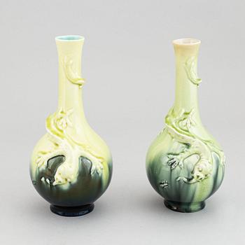 A pair of green glazed ceramic vases decorated with a lizard and an insect, Rörstrand, Sweden. Early 20th century.