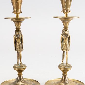 A pair of early 20th century brass candle sticks.