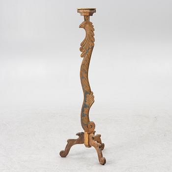 A carved wood floor candlestick, circa 1900 composed of 18th century elements.