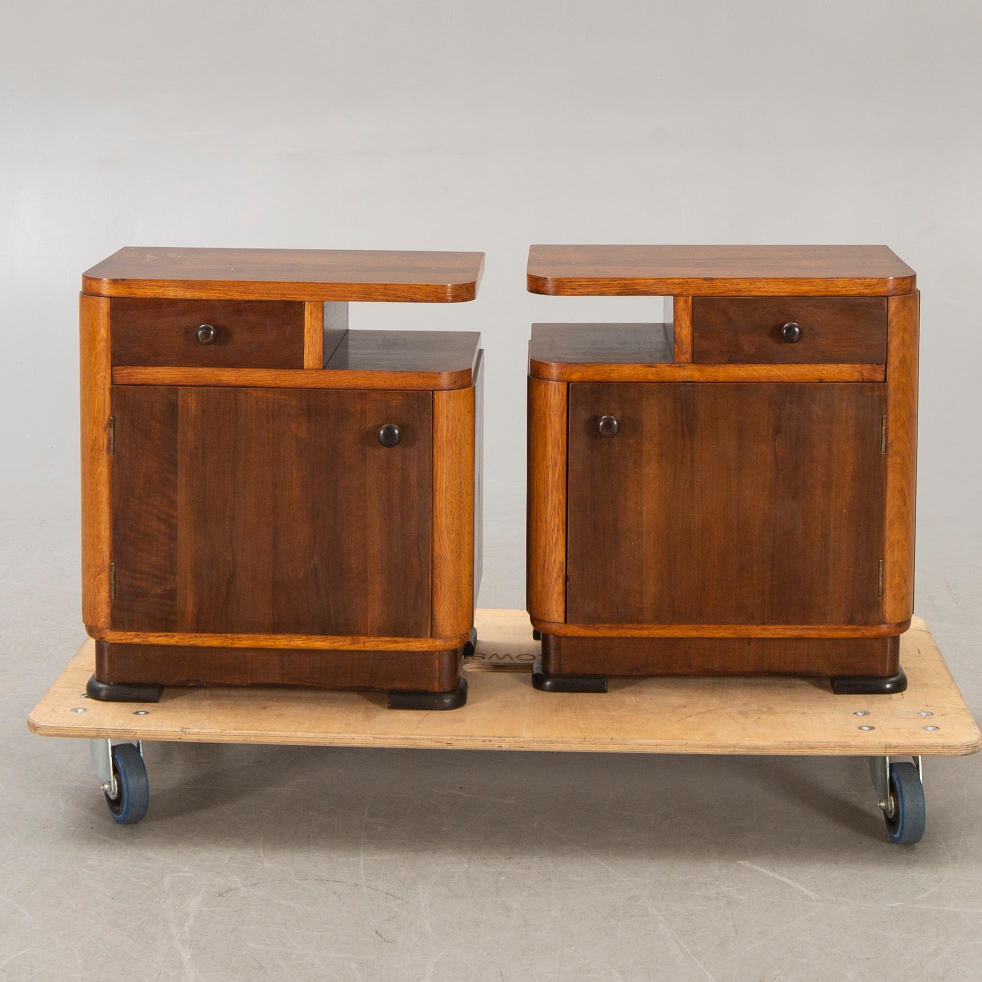 A pair of walnut/mahogany bedside tables first half of the 20th century.