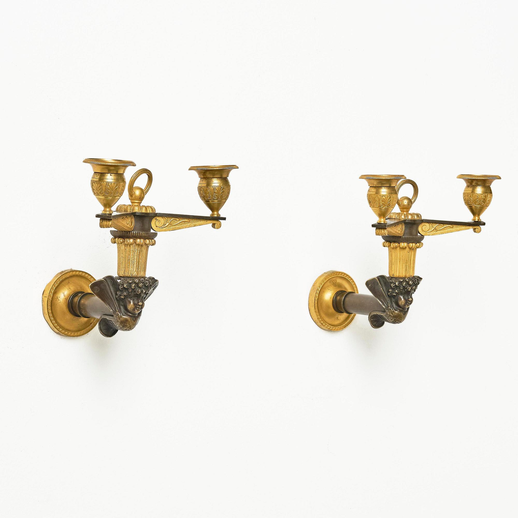 A pair of Empire patinated and ormolu two-branch appliques attr. to C. Galle (bronzier in Paris 1786-1815).