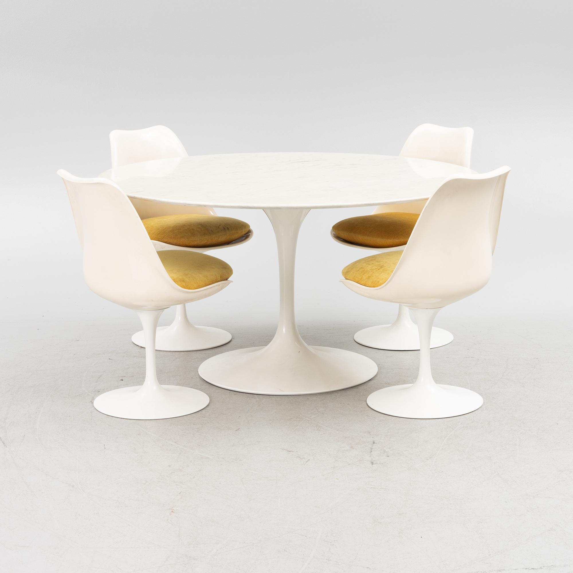 Eero Saarinen, a "Tulip" dining table with four chairs, 1970's.