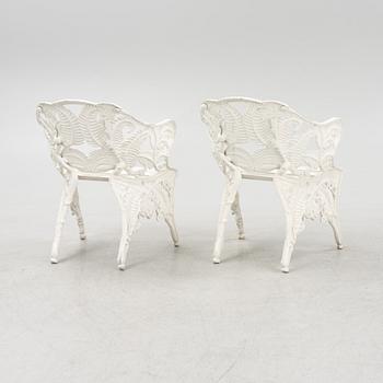 A painted pair of cast aluminum garden armchairs and a table, second part of the 20th Century.