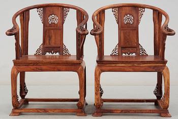 A pair of hardwood horseshoeback armchairs, late Qing dynasty, circa 1900.