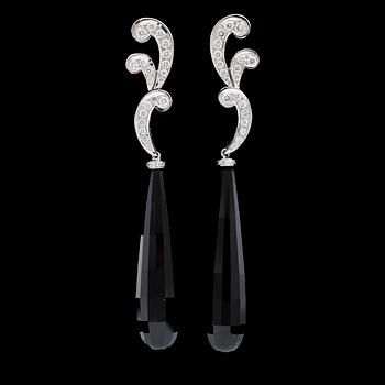 113. A pair of onyx and brilliant cut diamond earrings, total carat weight circa 0.73 cts.