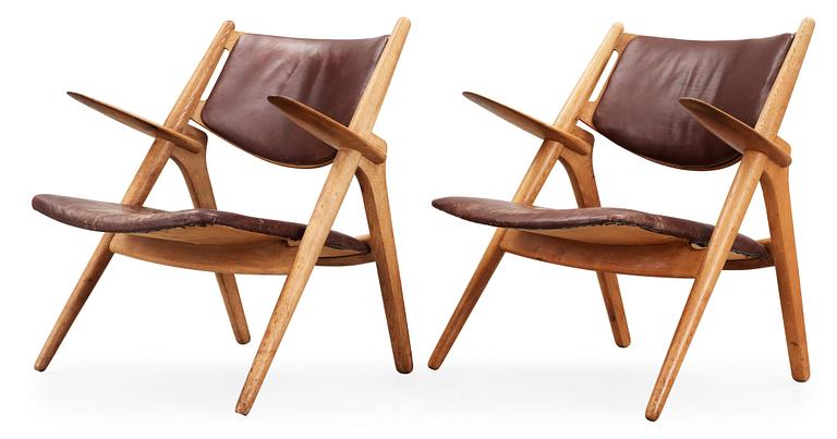 A pair of Hans J Wegner oak and brown leather easy chairs, Carl Hansen & Son, Denmark 1950's-60's.