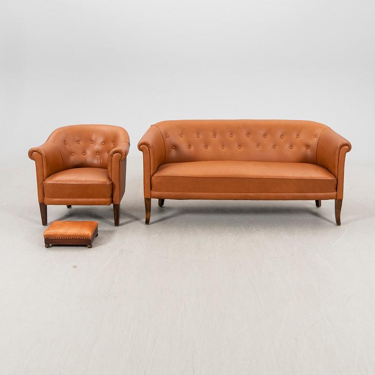 A leather sofa and armchair 1940s.