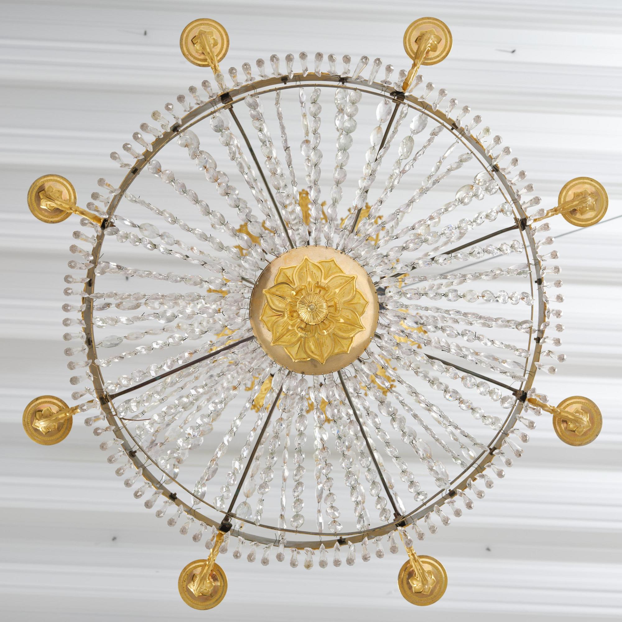 An French Empire eight-light gilt-brass and cut-glass chandelier.