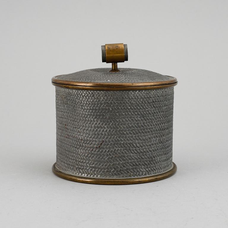 a pewter and brass jar with cover by Svenskt Tenn, Stockholm 1936.