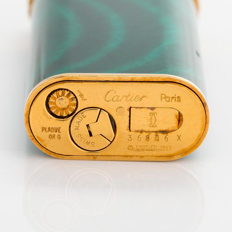 Cartier, A gilded and laquered metal lighter. Marked Cartier, Paris, 6846 X, Swiss made.