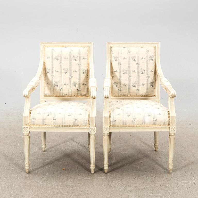 A pair of Gustavian style painted armchairs from around 1900.