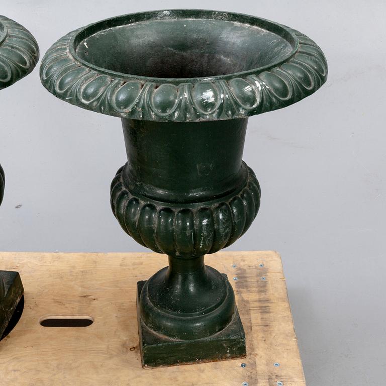 A pair of two 1990s cast iron garden urns.