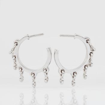 A pair of Dior white gold hoop earrings with 5 suspending brilliant-cut diamonds on each earring.