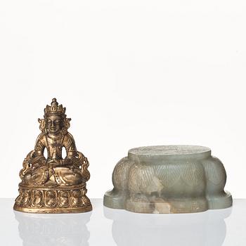 A gilt bronze figure of Amittayus seated on a later base of nephrite, Tibeto-Chinese, late 19th Century.