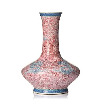 1059. A rare pink and blue enamelled vase with dragons, late Qing dynasty/Republic with an apocryphal Qianlong mark.