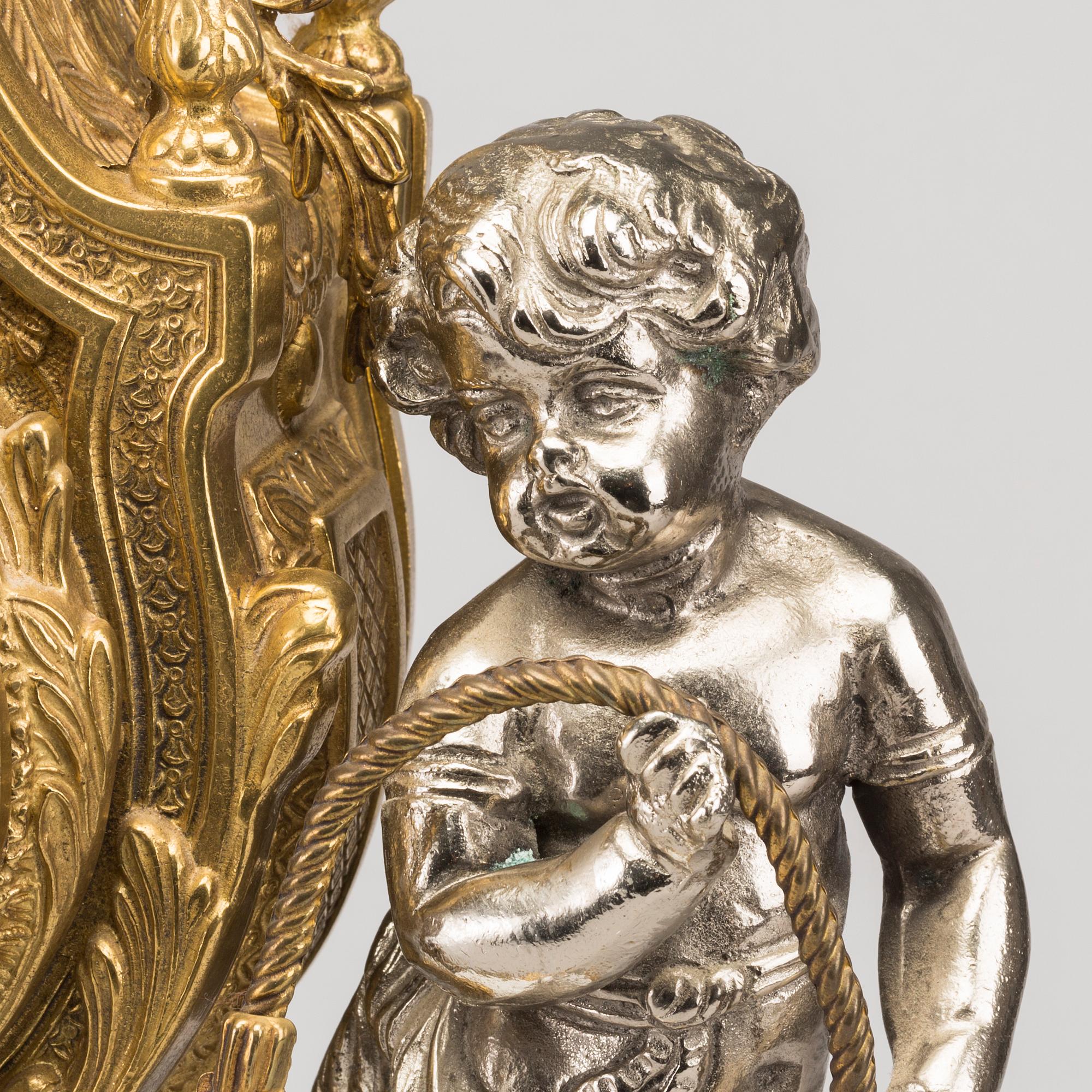 A LOUIS XVI STYLE GILT-BRASS CLOCK GRANITURE. Italy, SECOND HALF OF 20TH CENTURY.