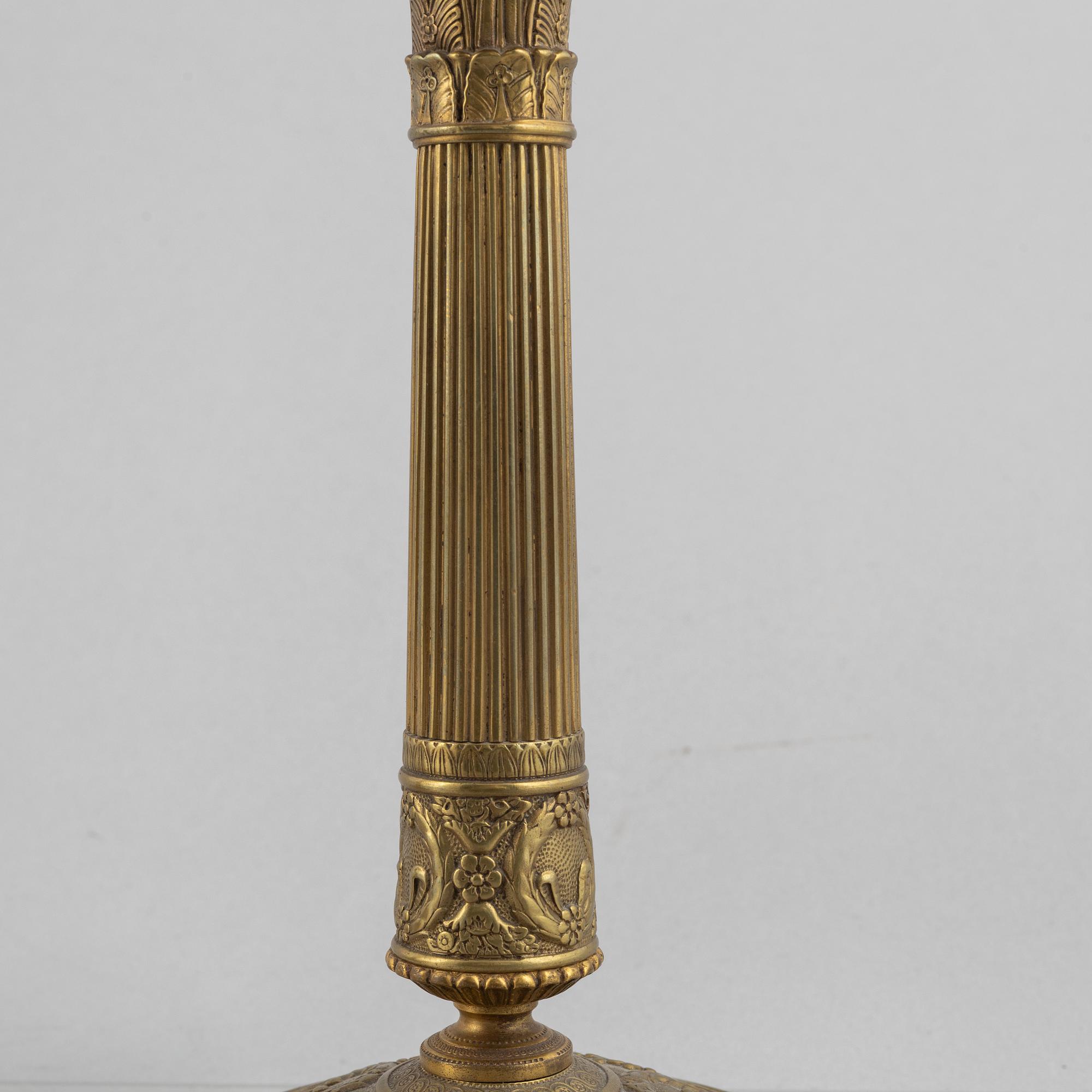 A pair of Empire gilt brass candle sticks, first half of the 20th century.