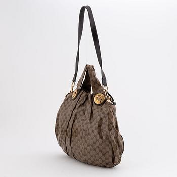 Gucci, a canvas handbag.