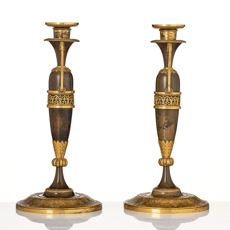 A pair of French Empire ormolu and patinated candlesticks in the manner of Claude Galle, Paris, early 19th century.